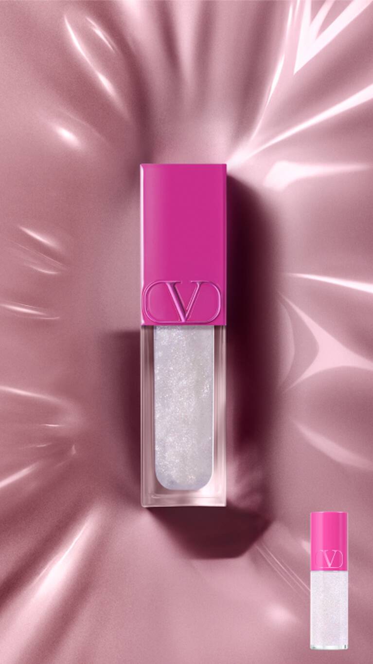 Un lucidalabbra Valentino con tappo fucsia e gloss bianco brillante su una superficie rosa riflettente. Una versione piu piccola e in basso a destra.